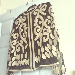 Black mesh jacket with beige leather trim.